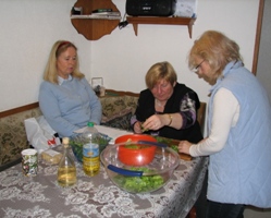 Teilnehmer bei der Zubereitung des Wildkr&auml;uter-Salats